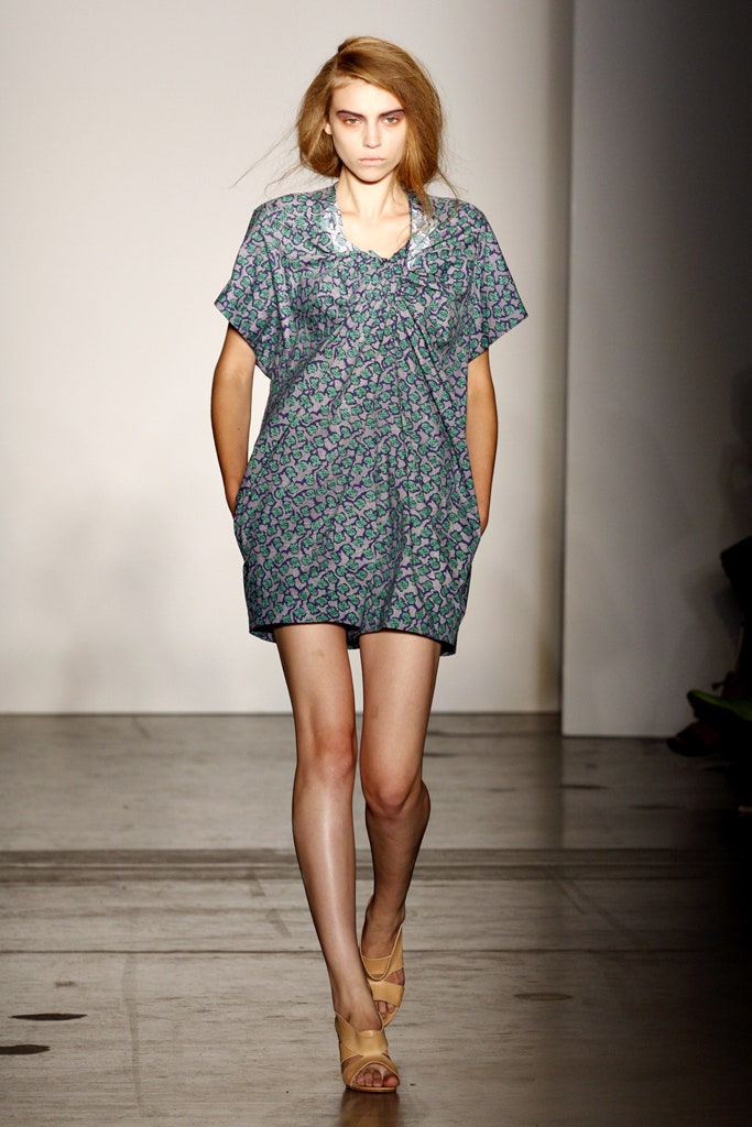 A relaxed blue cotton dress with short sleeves and a collared neckline featuring a printed design.