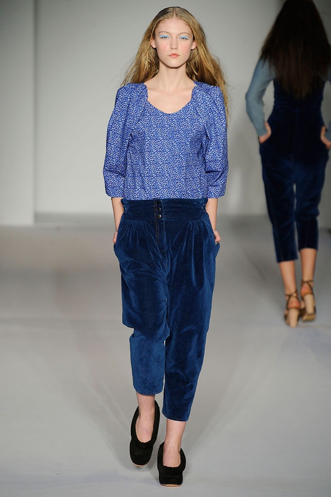 A relaxed blue printed top with long sleeves paired with wide-leg velvet pants.