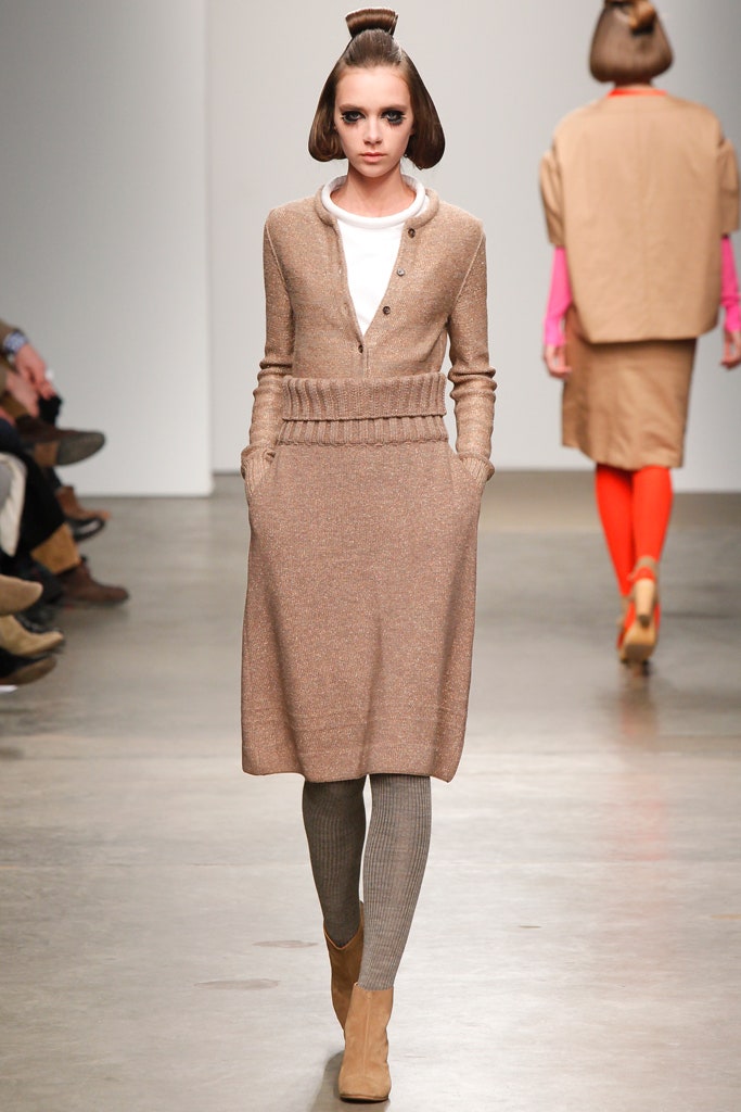 A fitted beige wool long-sleeve dress with a collared neckline and knit texture.
