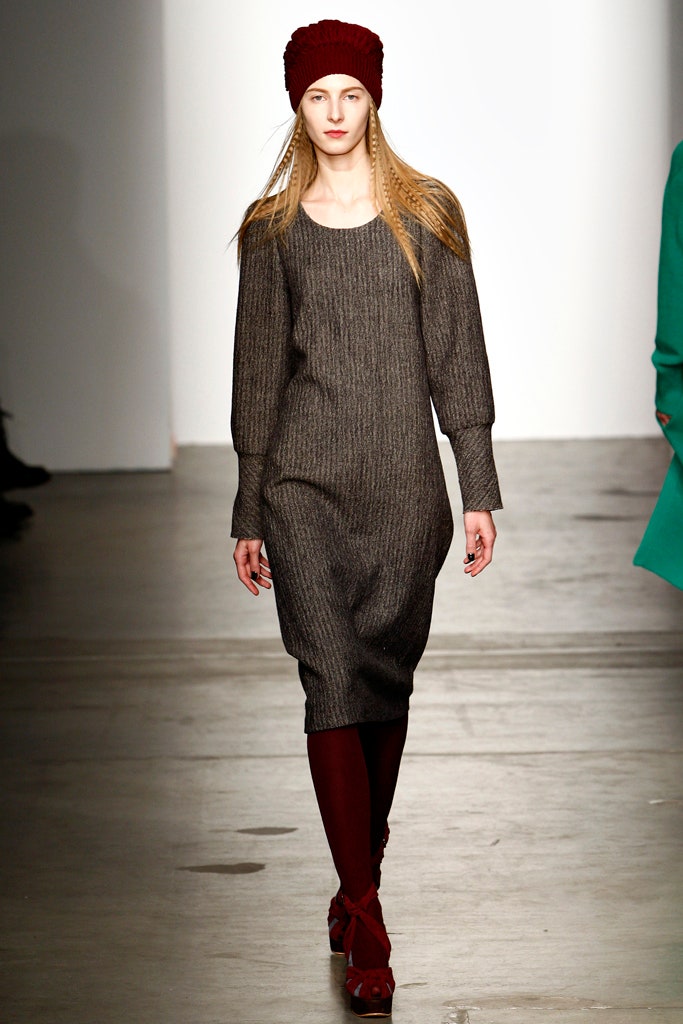 A relaxed gray knit dress with long sleeves and an asymmetric design.