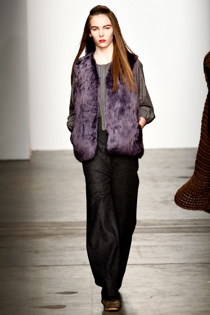 purple faux-fur vest with gray shirt and black pants