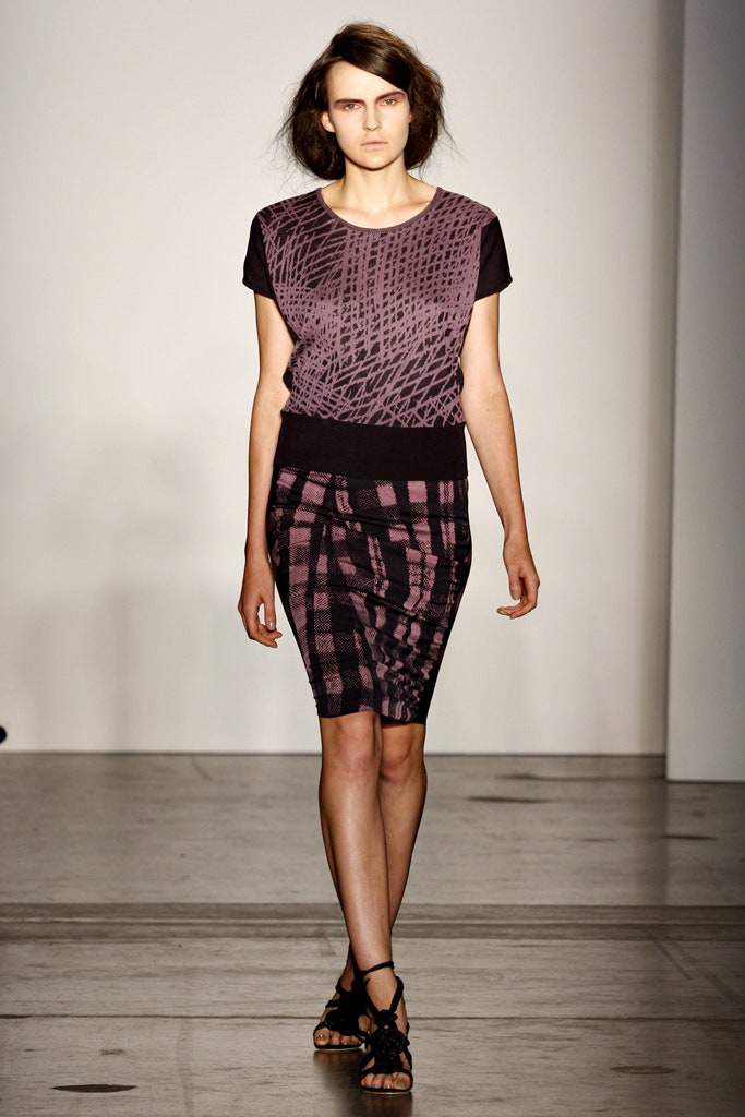 A fitted black and purple printed top paired with a pencil skirt, showcasing a modern silhouette.