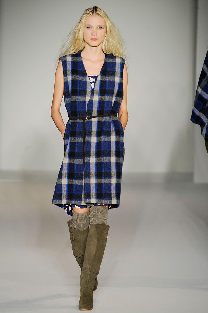 A relaxed blue checked sleeveless dress with a collared design.