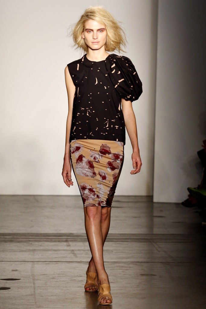 A fitted black top with a V-neck and an asymmetric printed skirt.