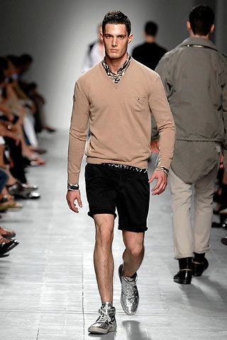 beige fitted sweater with black shorts