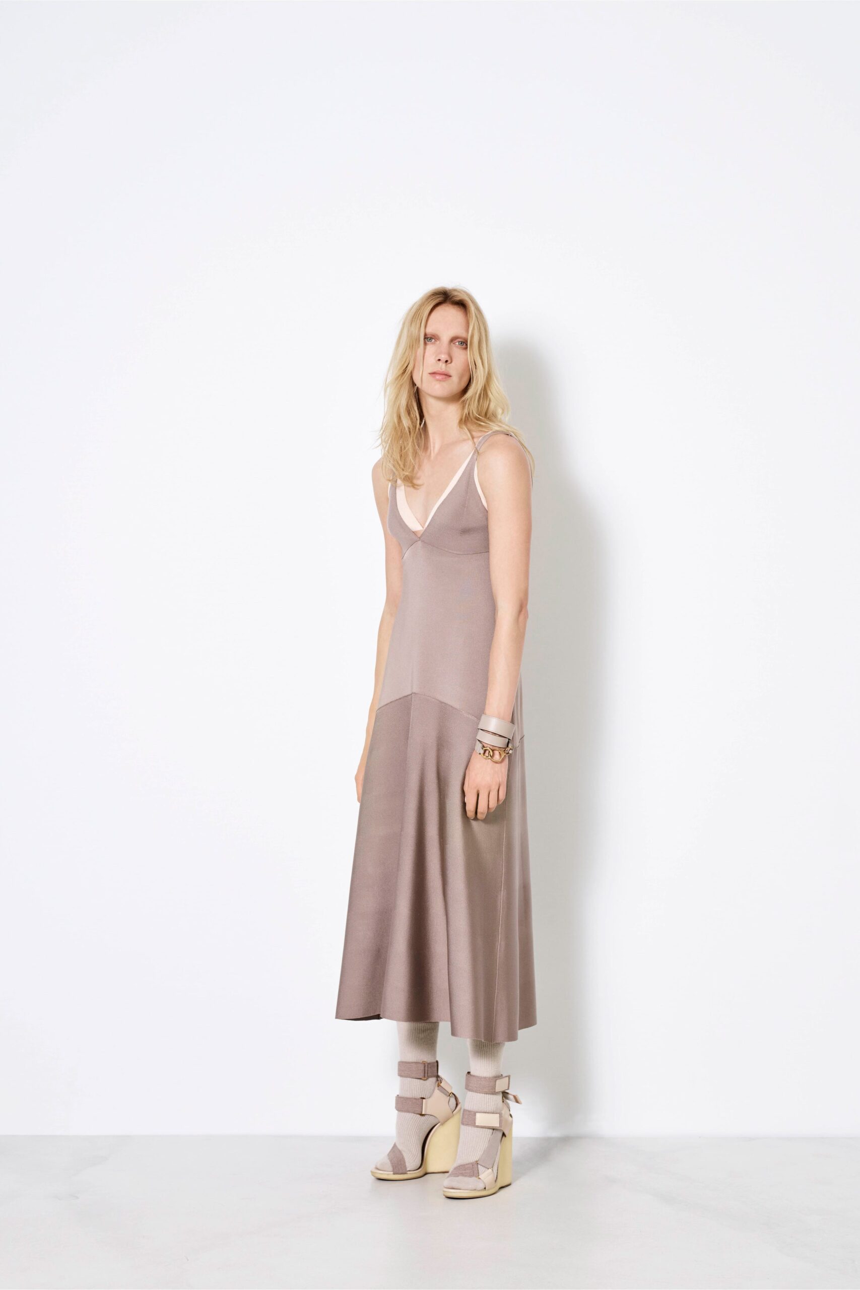 beige silk sleeveless dress and strappy shoes