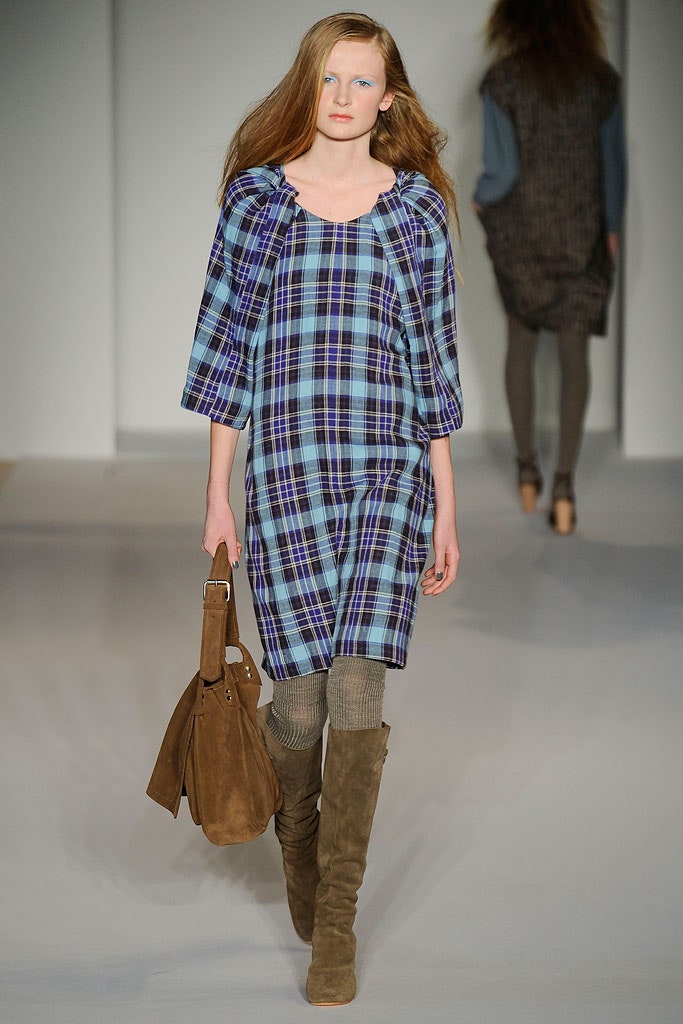 A relaxed blue checked dress with short sleeves and a collared neckline.