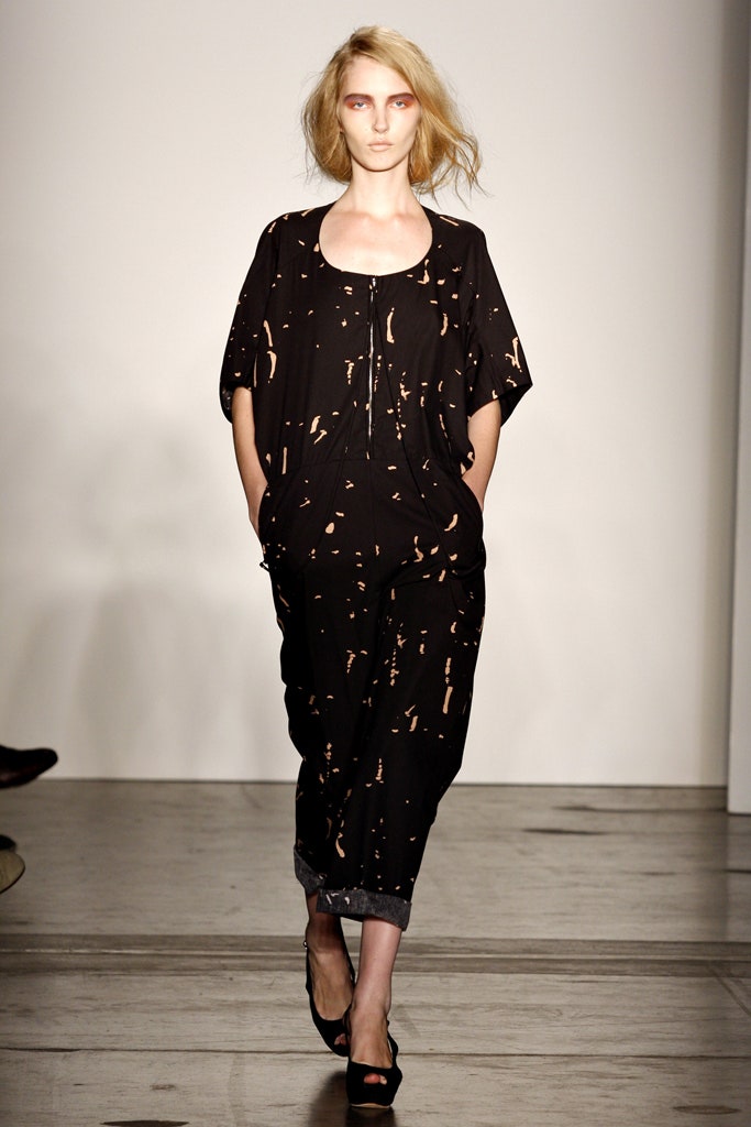A relaxed black jumpsuit with short sleeves and a printed design.