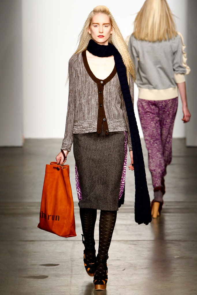 A fitted gray wool cardigan with a collared design paired with a pleated purple skirt.