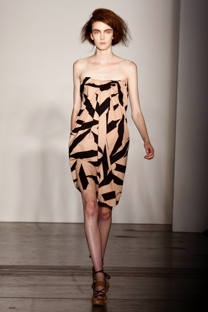 A relaxed beige and black printed dress with a strapless design and sleeveless construction.