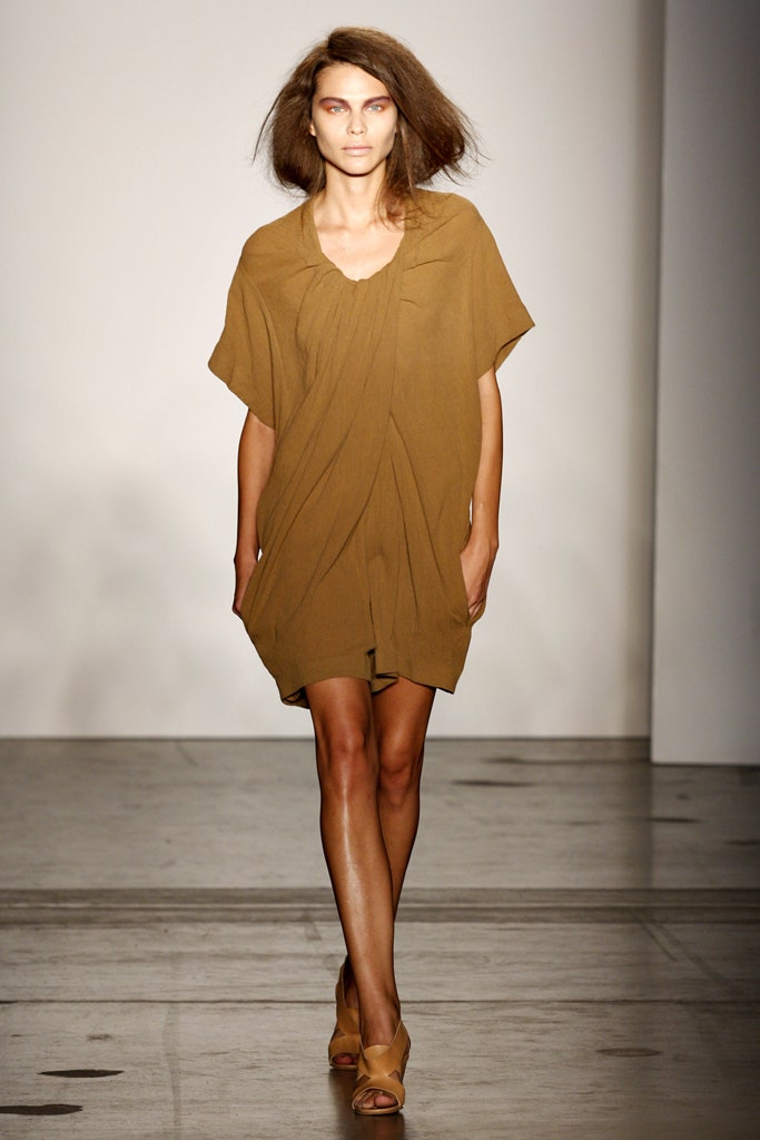 A relaxed brown sleeveless dress with a V-neckline and draped design.