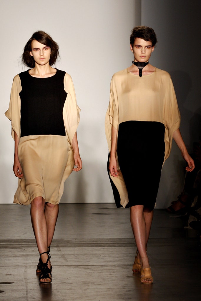 A relaxed black and beige dress with a high neckline and asymmetric design.