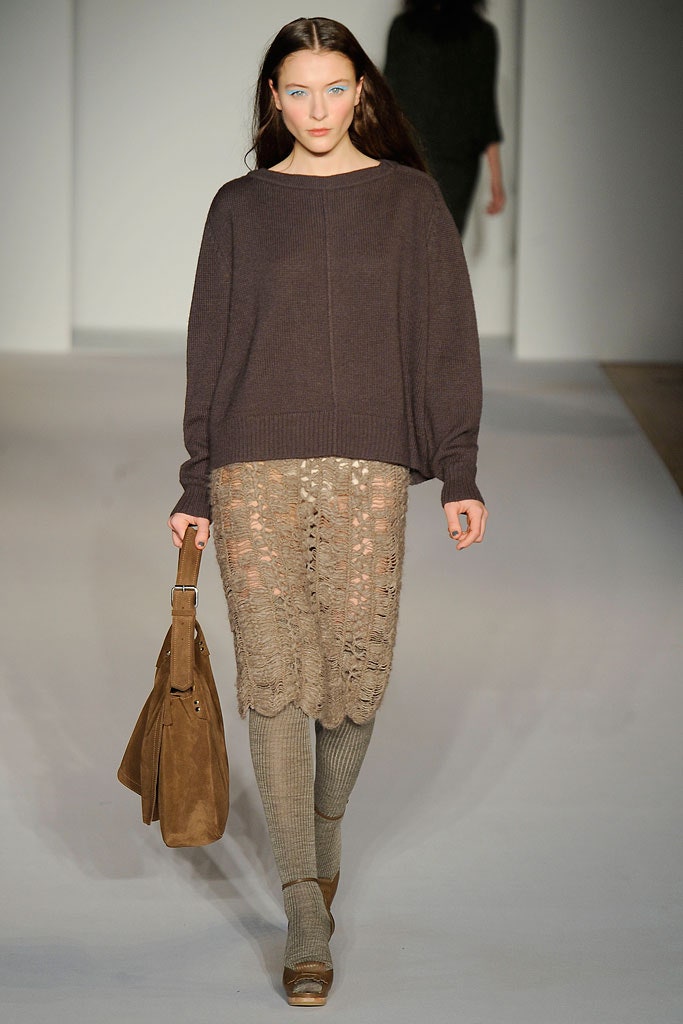 A relaxed brown wool long-sleeve sweater paired with a layered beige lace skirt.
