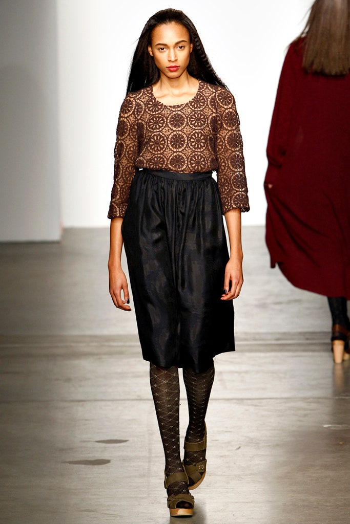 A relaxed brown printed dress with three-quarter sleeves and a round neckline.