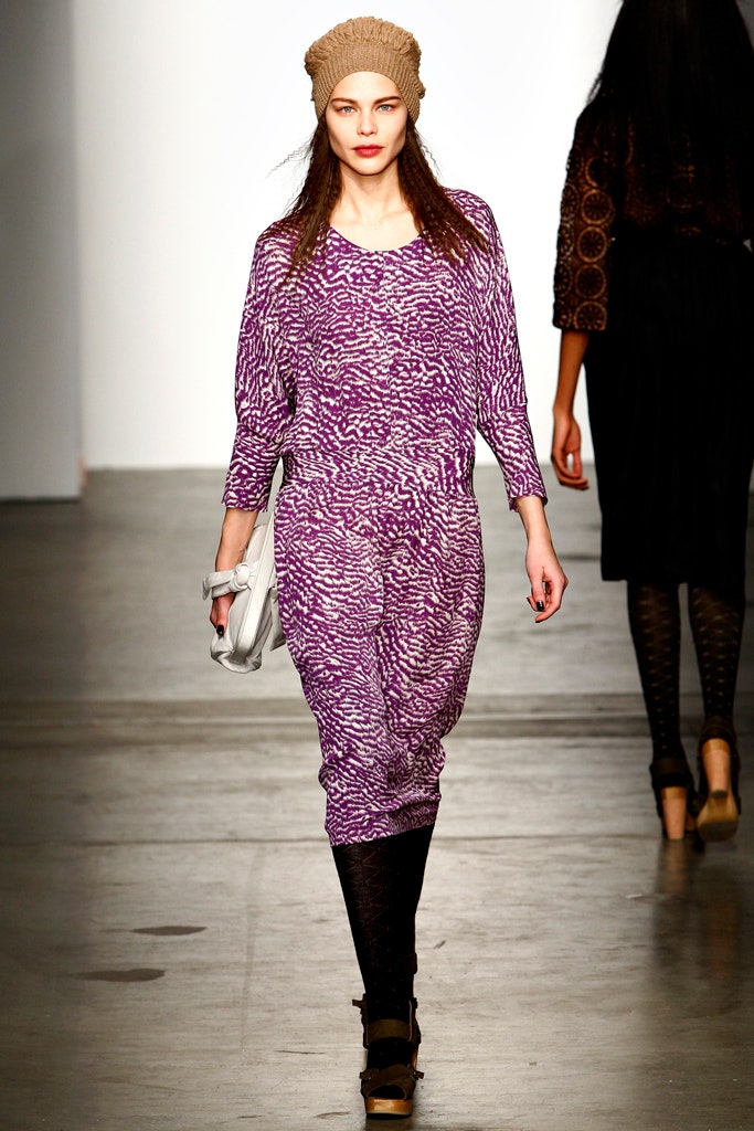 A relaxed purple printed jumpsuit with long sleeves and a V-neckline.