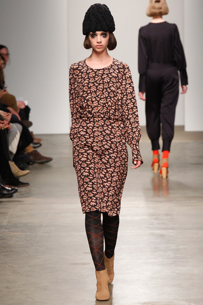 A fitted brown floral long-sleeve dress with a collared neckline.