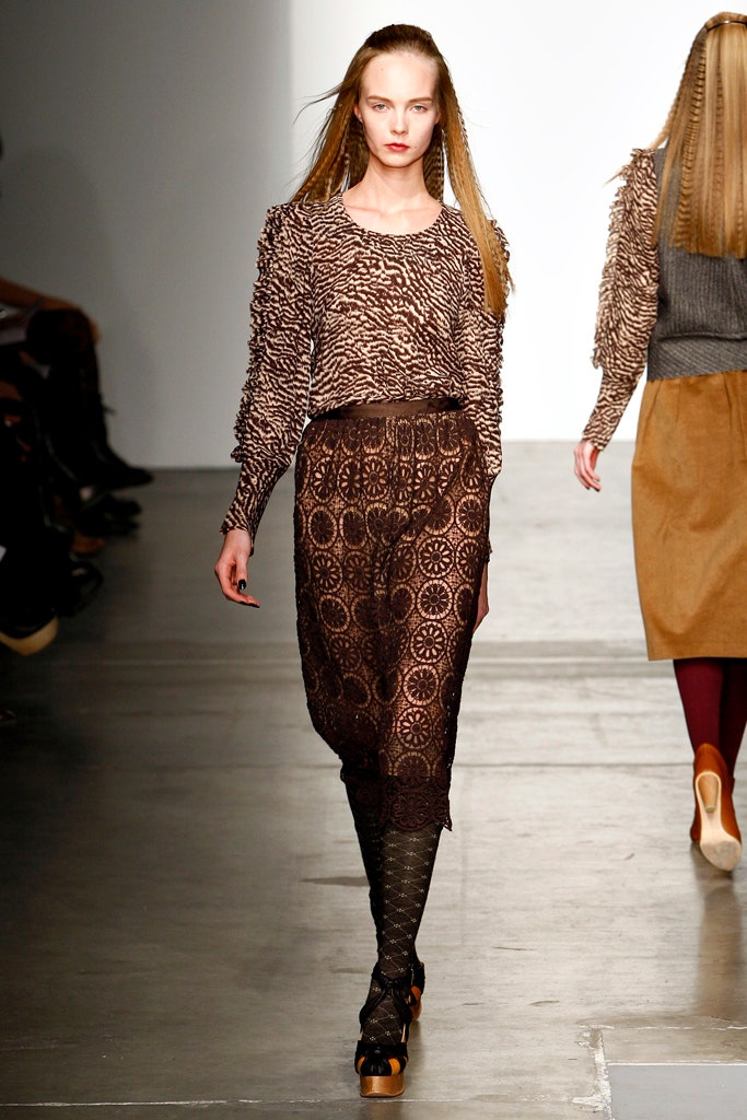 A fitted brown printed long-sleeve top paired with matching fitted pants.
