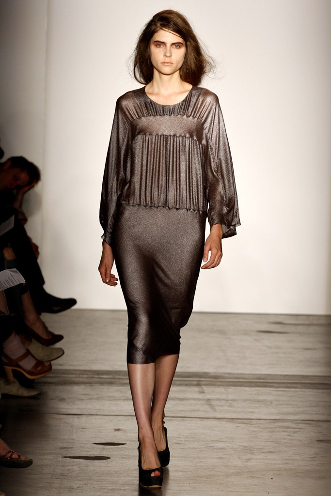 A fitted brown silk dress with long sleeves and a pleated design in a midi length.