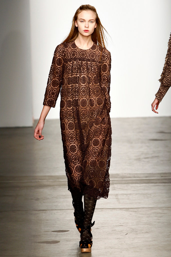 A relaxed brown lace dress with long sleeves and an embroidered design.