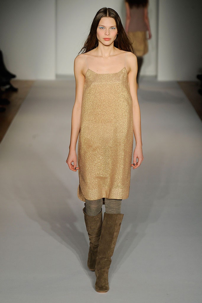 A relaxed gold silk sleeveless dress with a V-neckline and straight-leg silhouette.