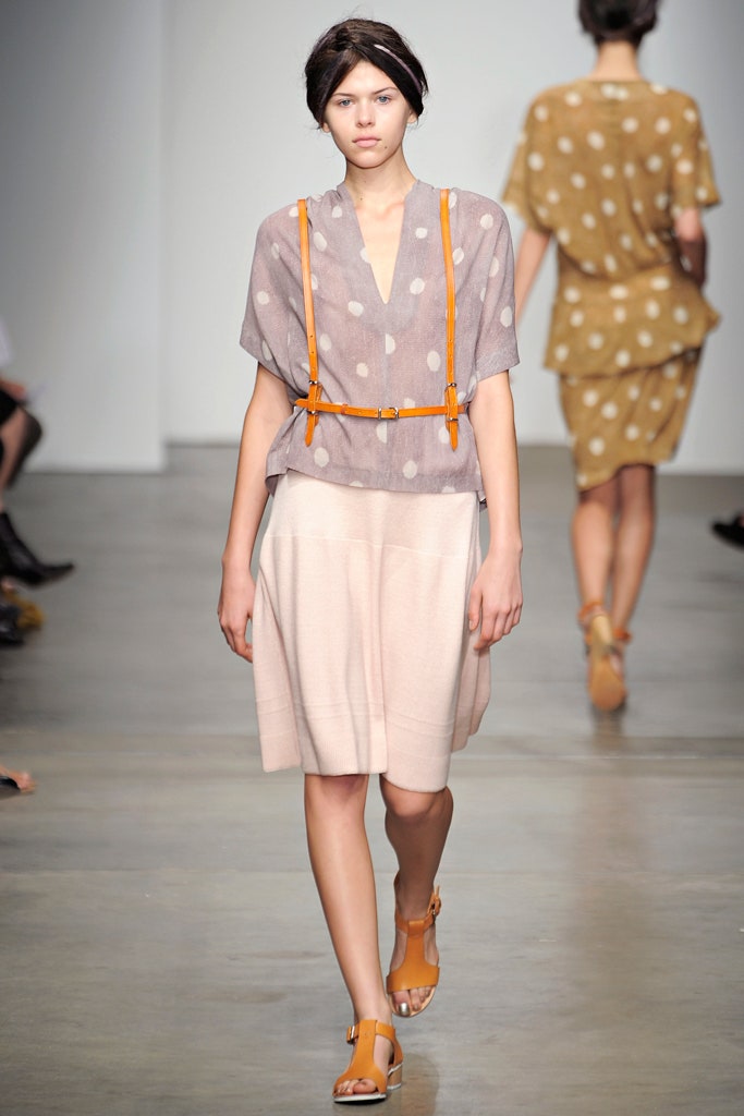 A relaxed beige polka-dot top paired with a layered beige skirt.