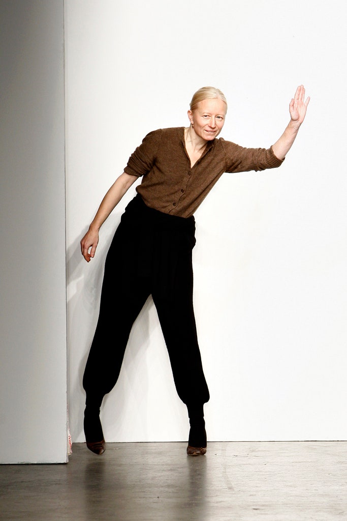 A relaxed brown cotton long-sleeve top paired with black relaxed pants.