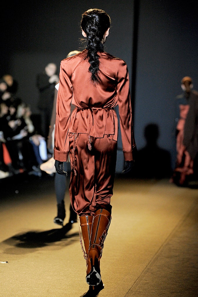 red silk fitted jumpsuit with orange boots