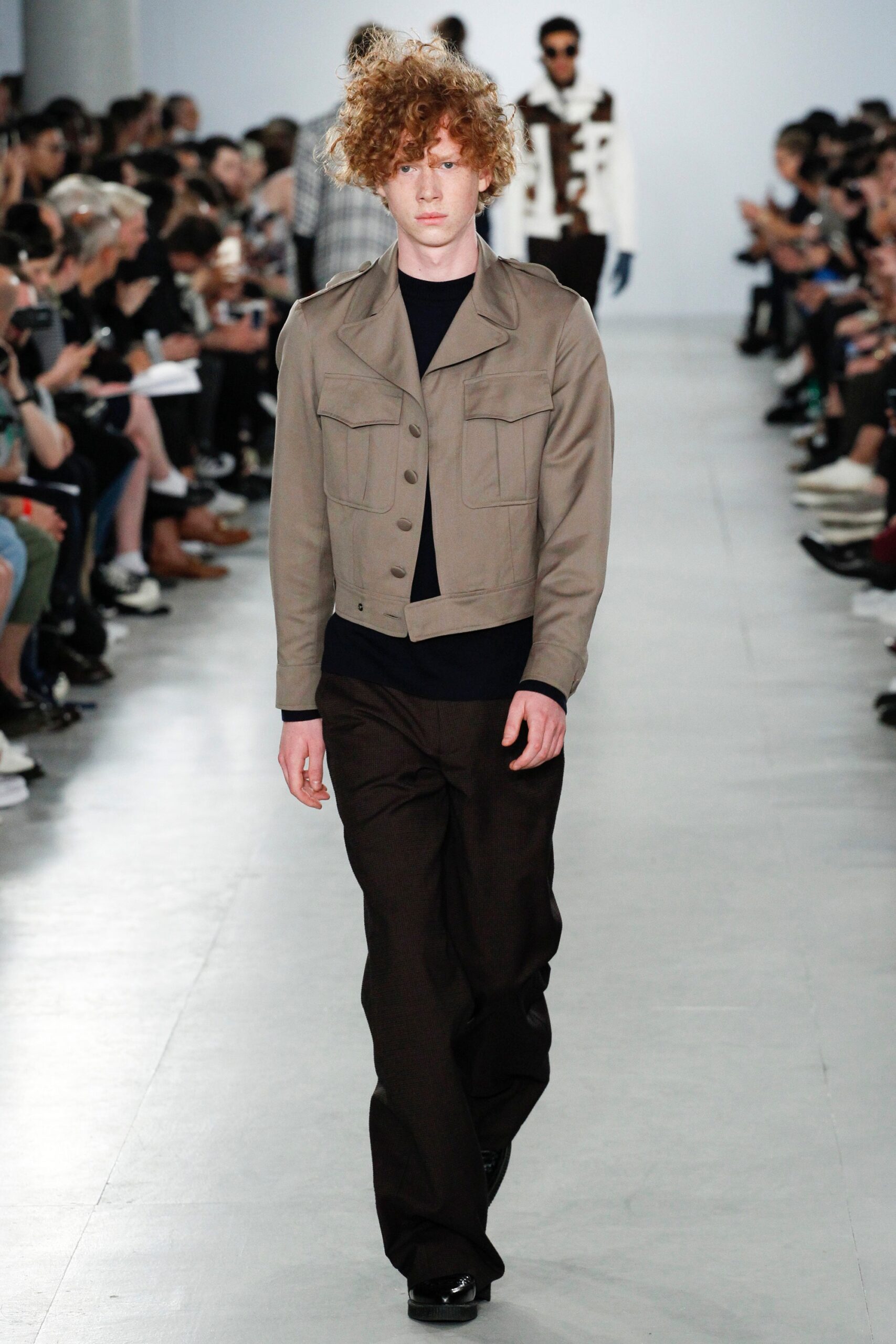 beige fitted jacket with black shirt and brown pants