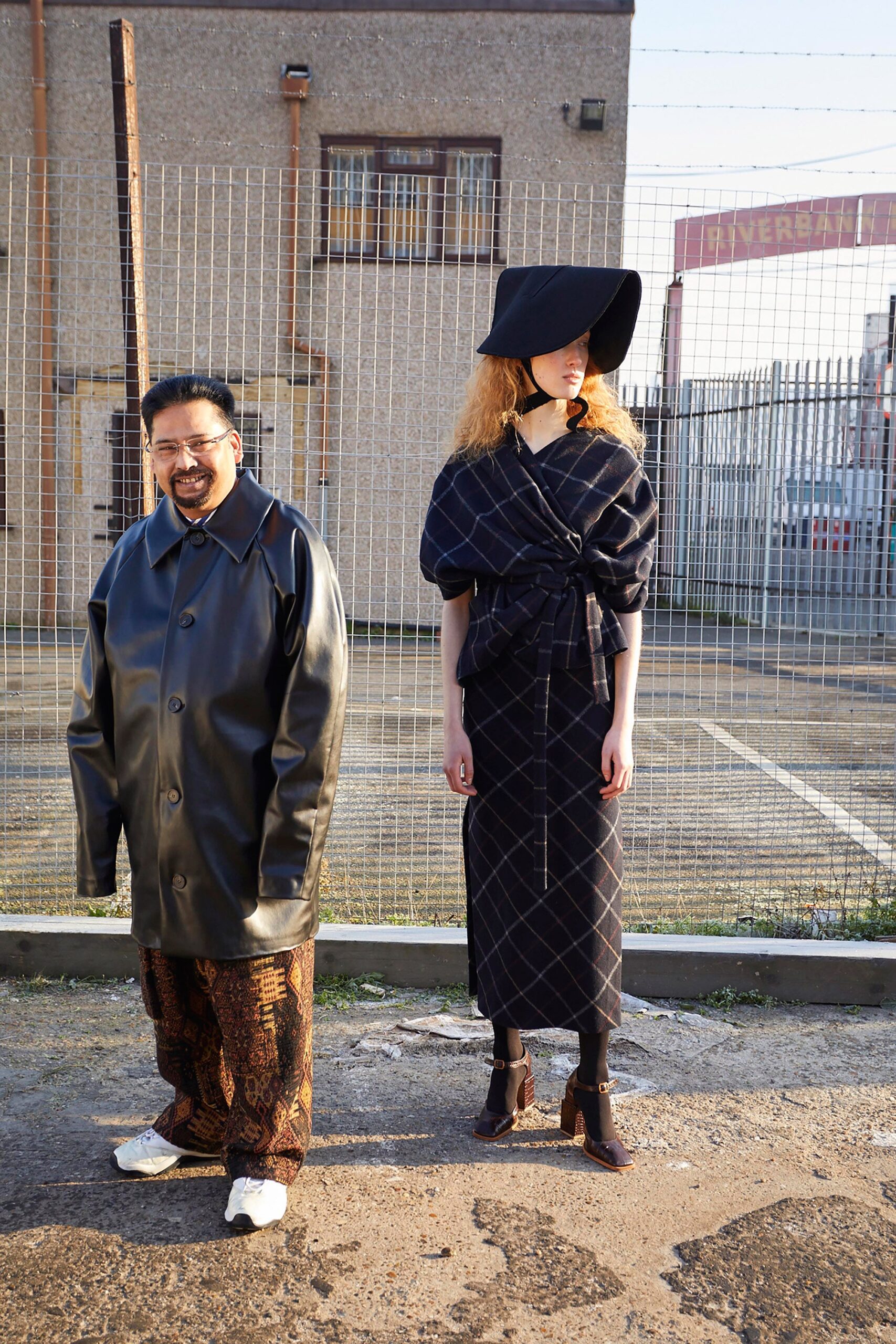 black fitted midi dress and oversized leather coat