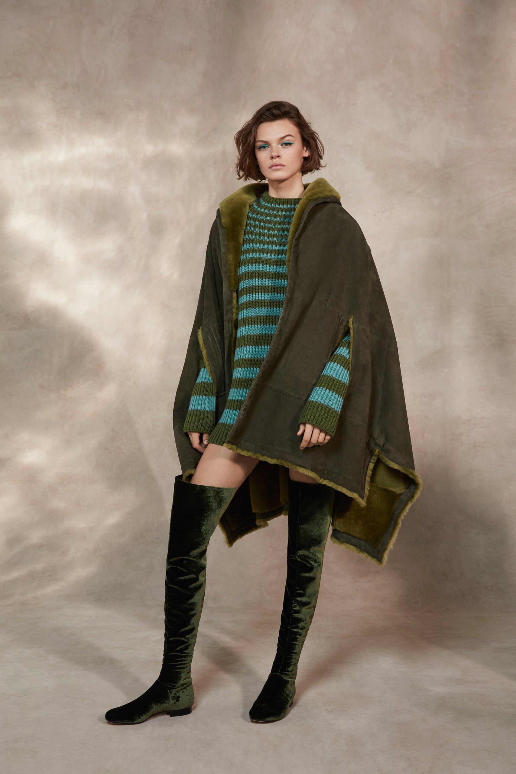 green faux-fur poncho with striped dress