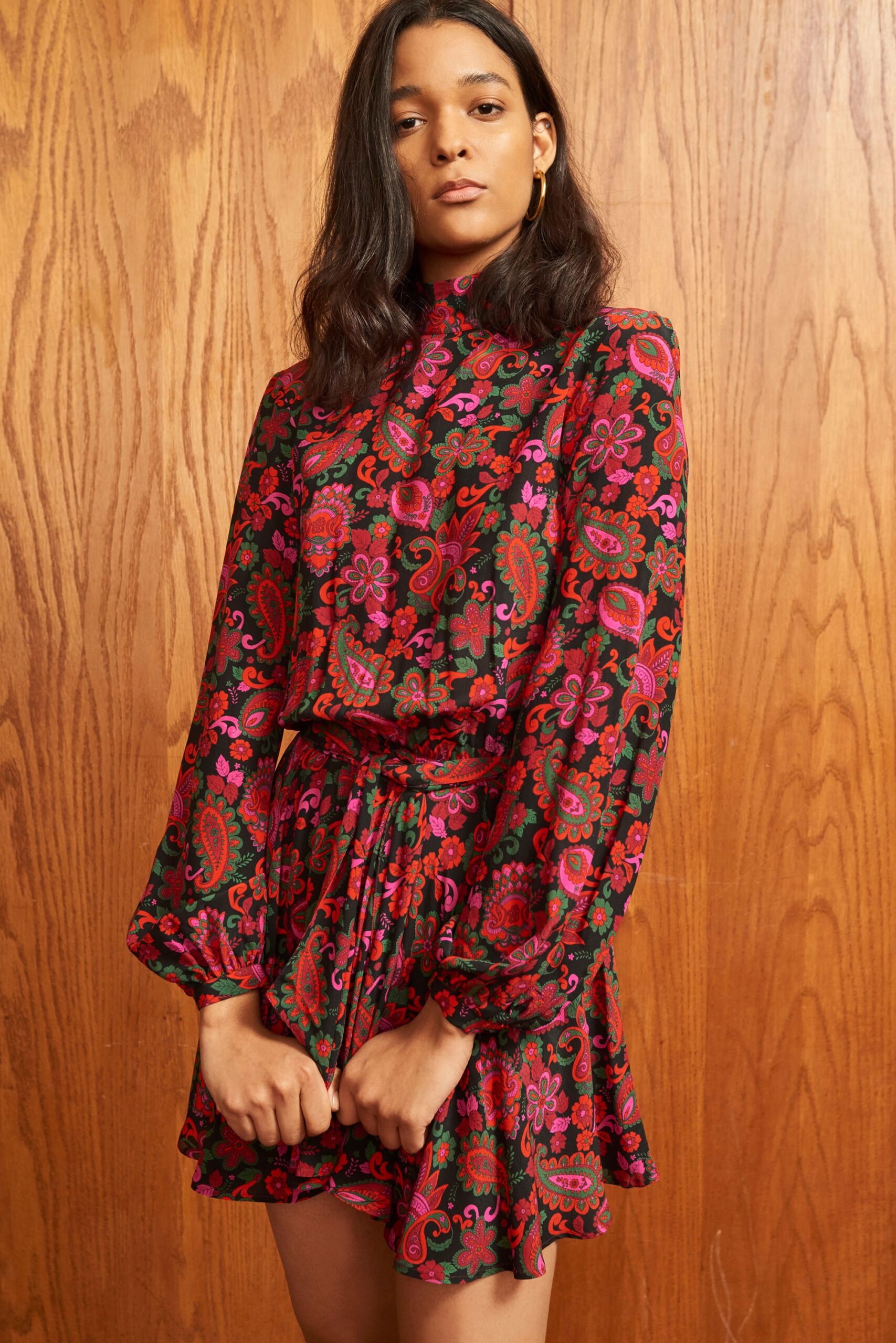 A fitted flared dress with long sleeves, a collared neckline, and a vibrant floral print.