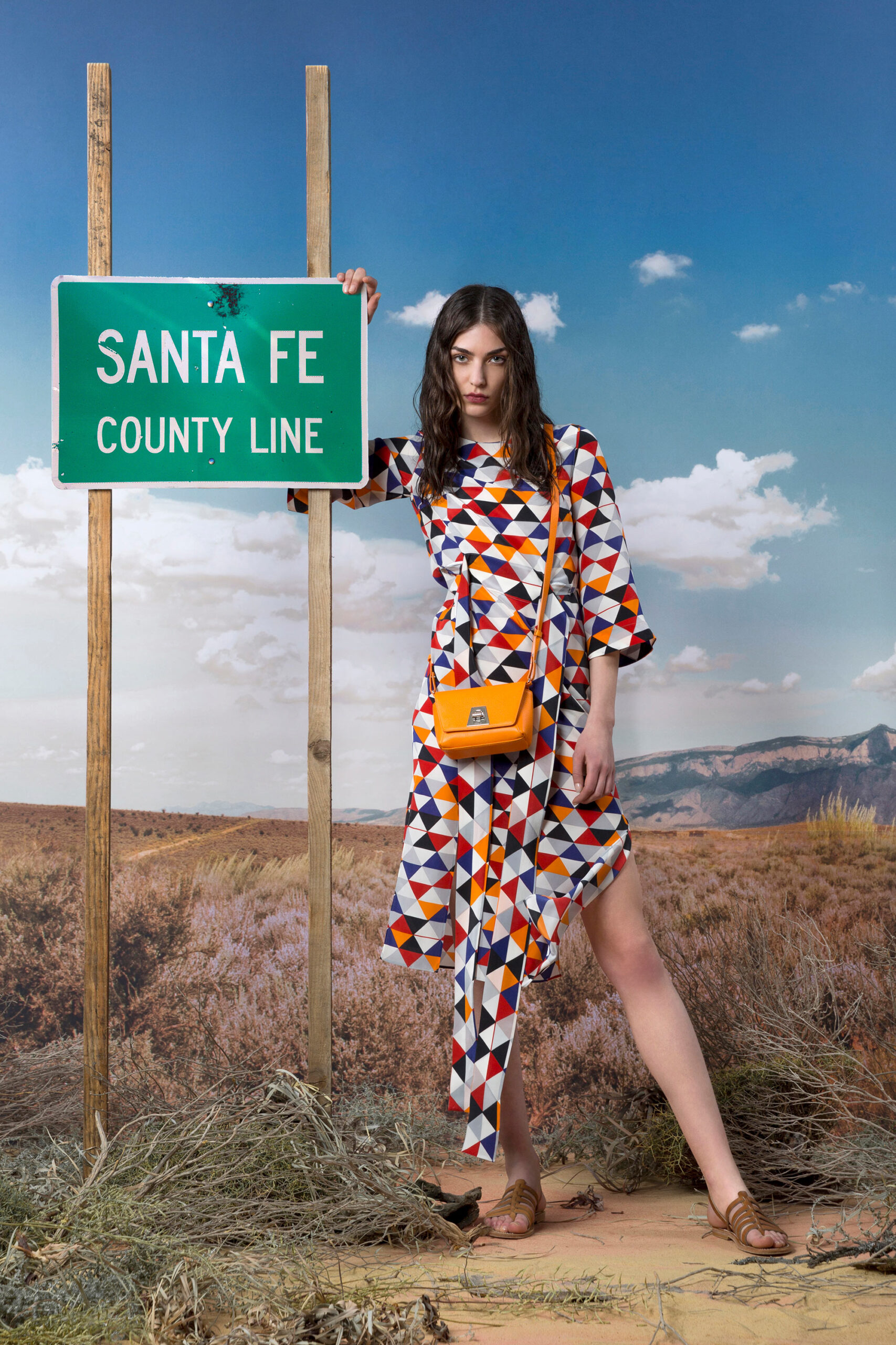 printed midi dress with orange bag