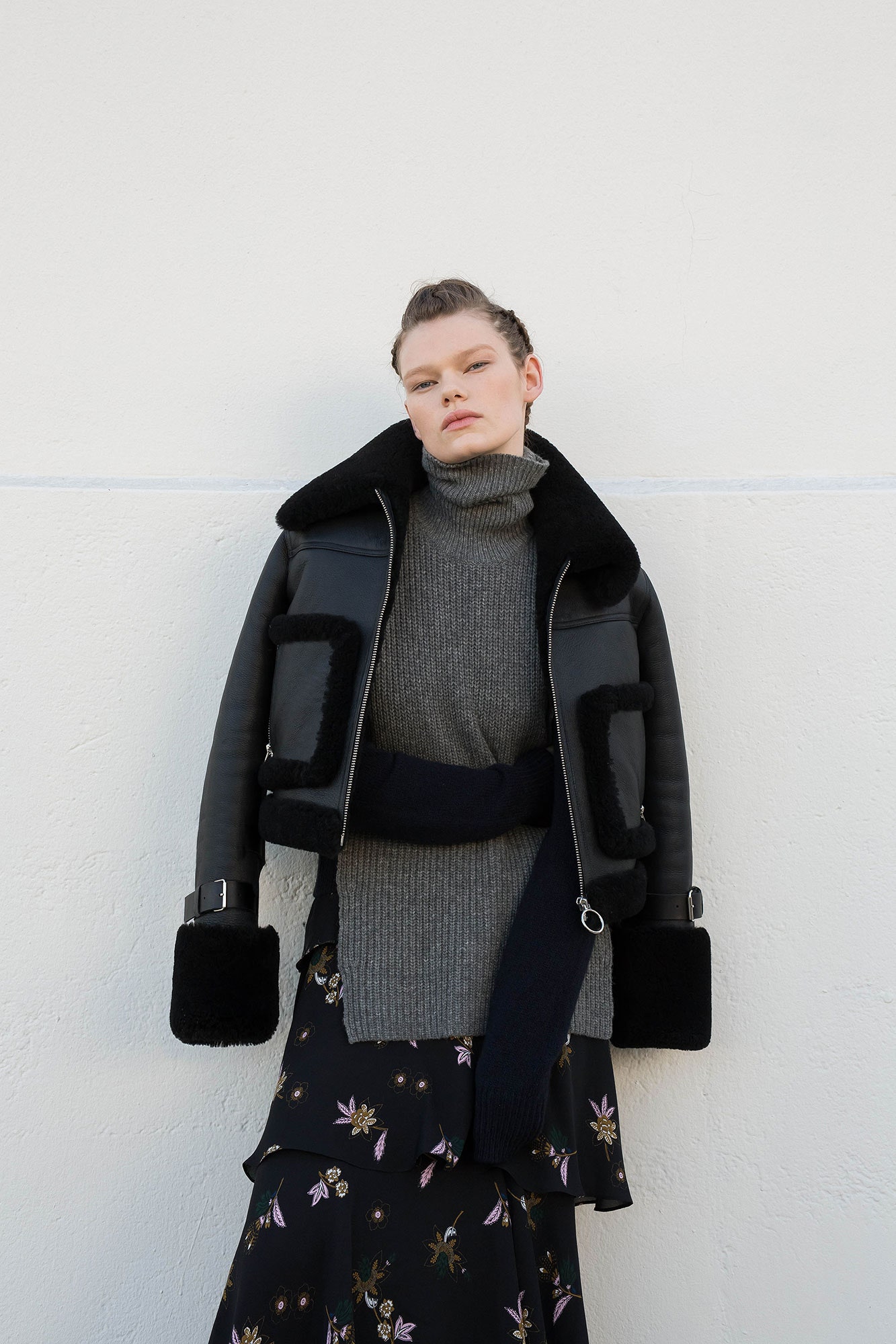 black leather jacket gray sweater black skirt