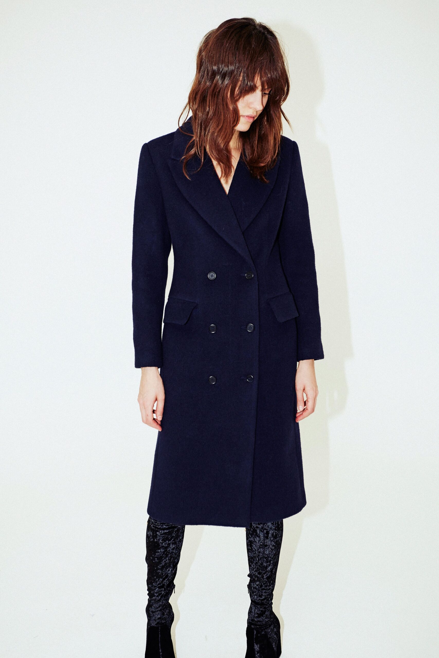blue tailored coat with black pants