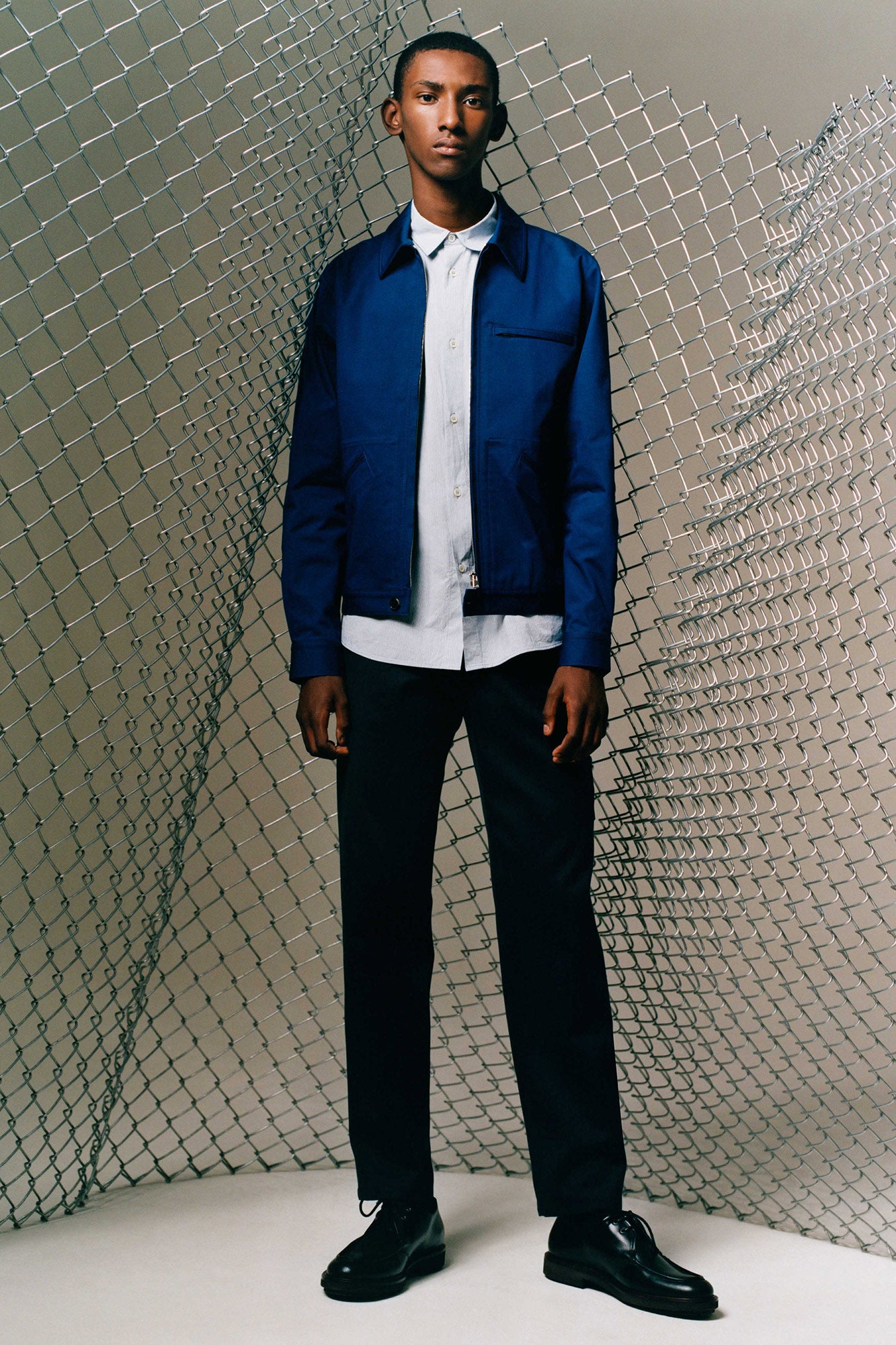 blue jacket white shirt black pants