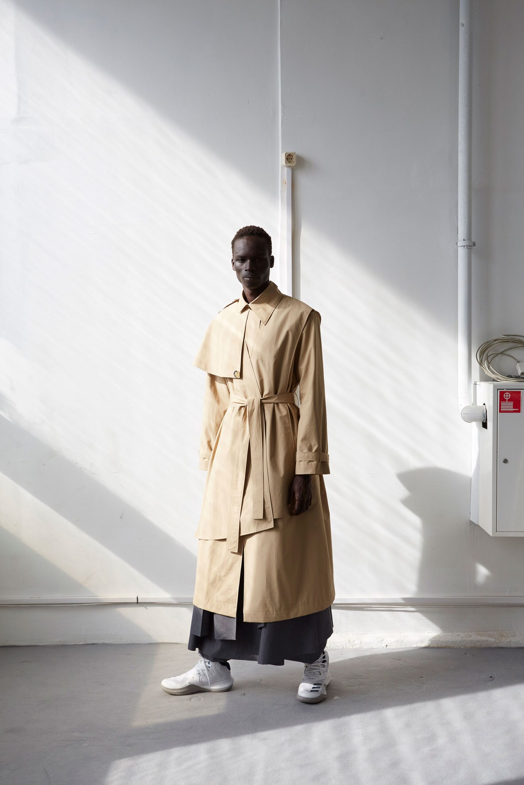 beige trench coat with black skirt