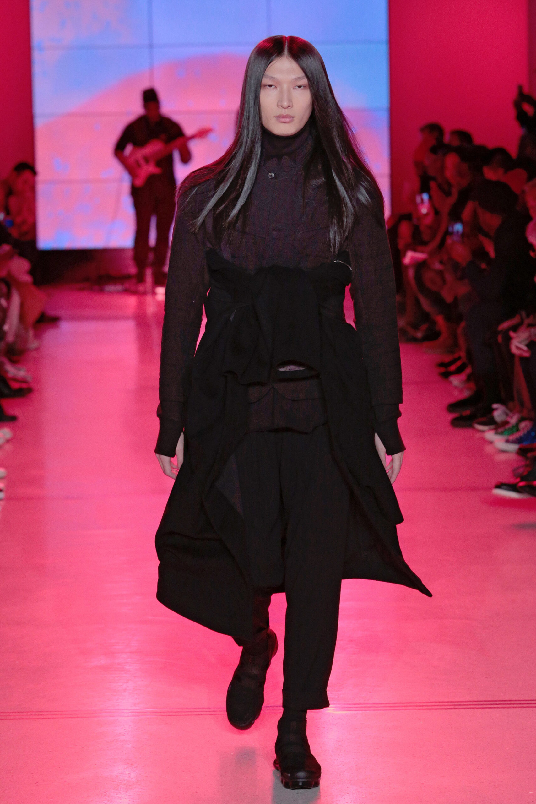 black fitted coat and relaxed pants