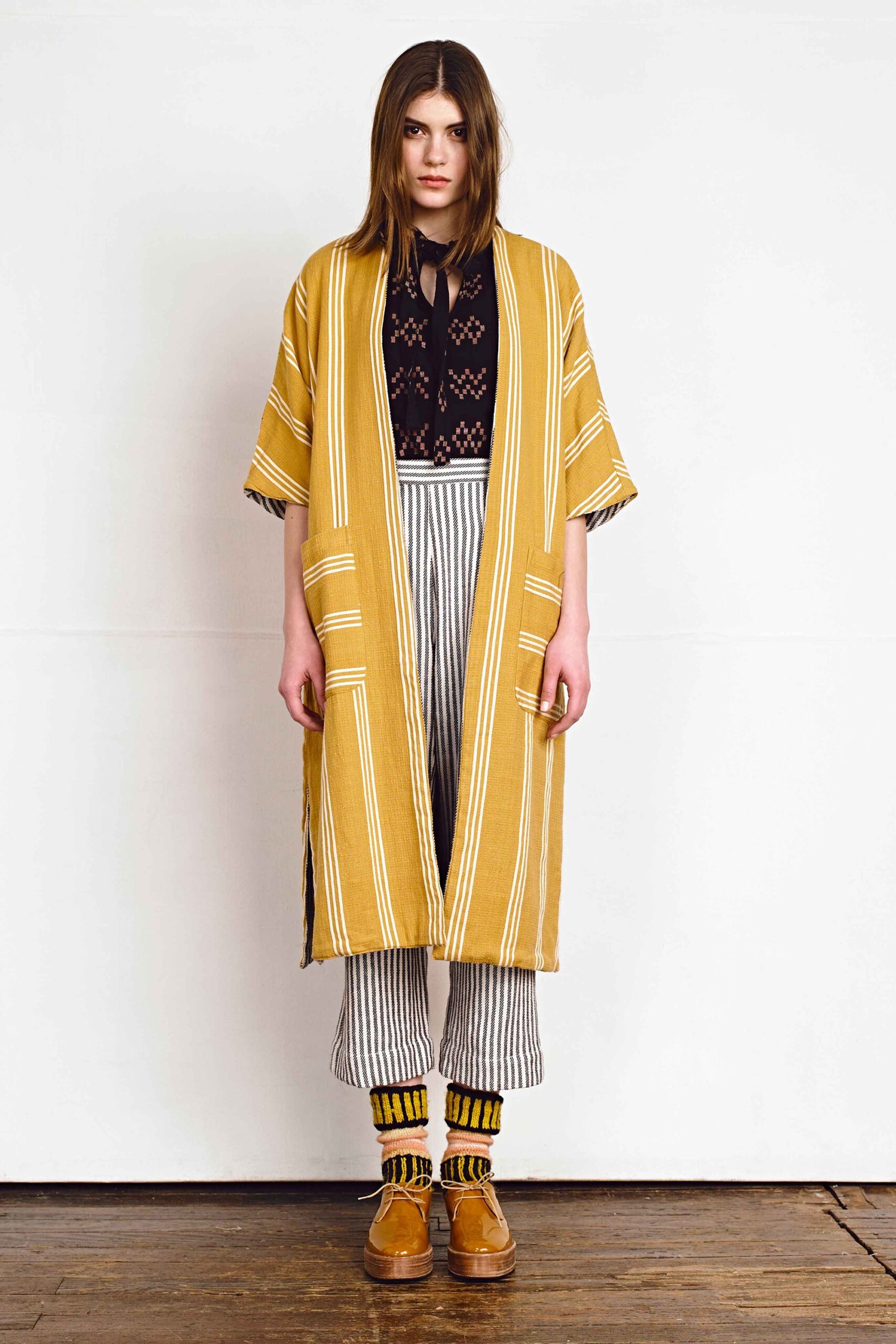 yellow striped coat with black lace blouse