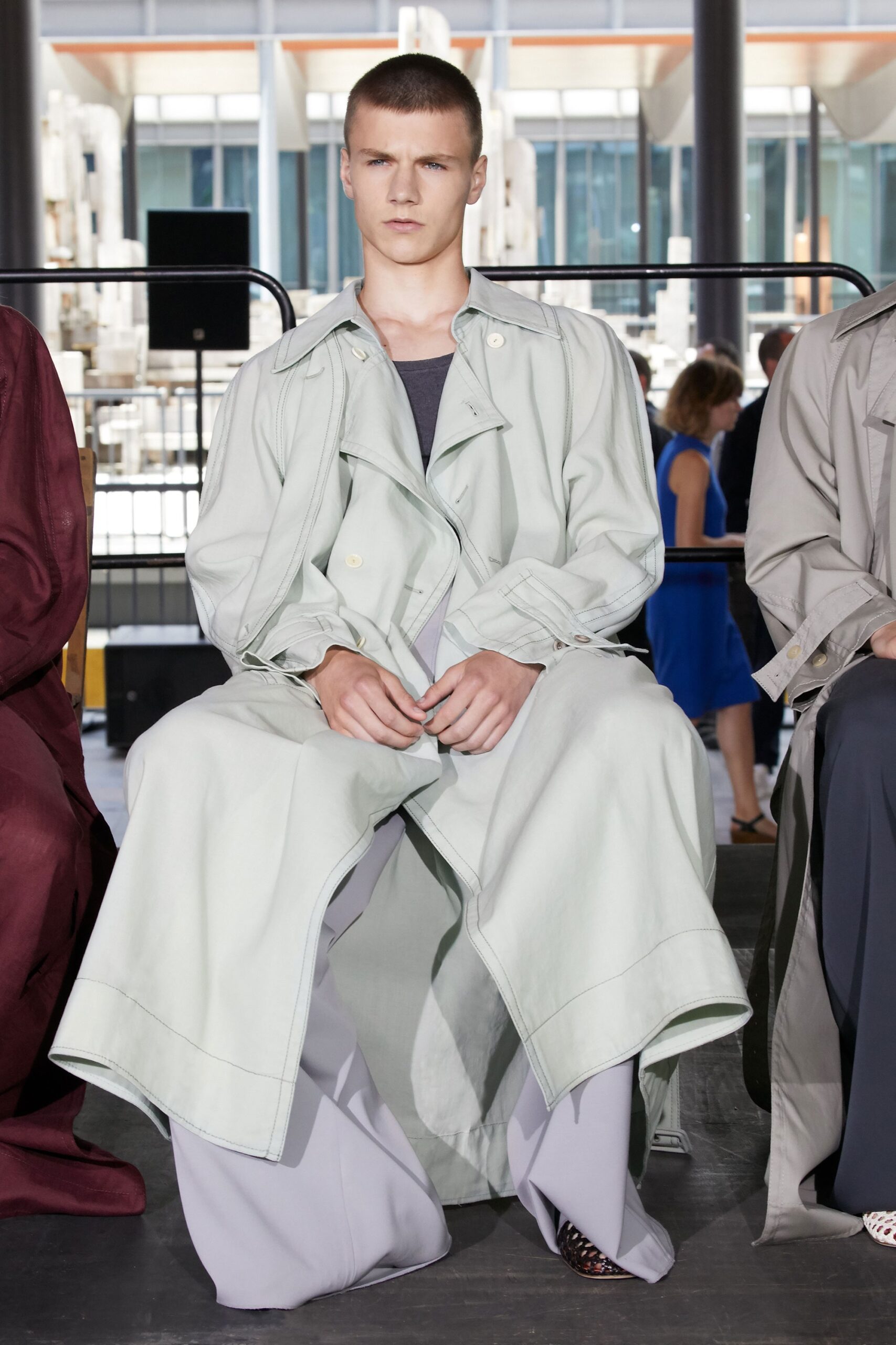 light green trench coat with gray pants