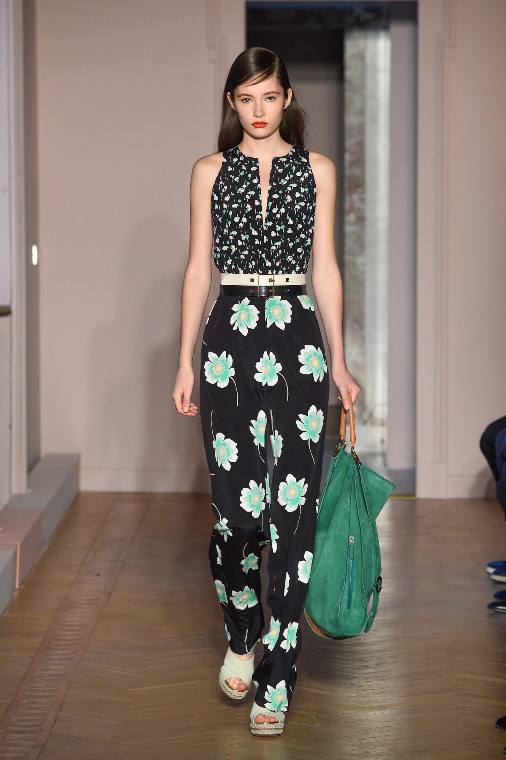 floral black jumpsuit with green bag