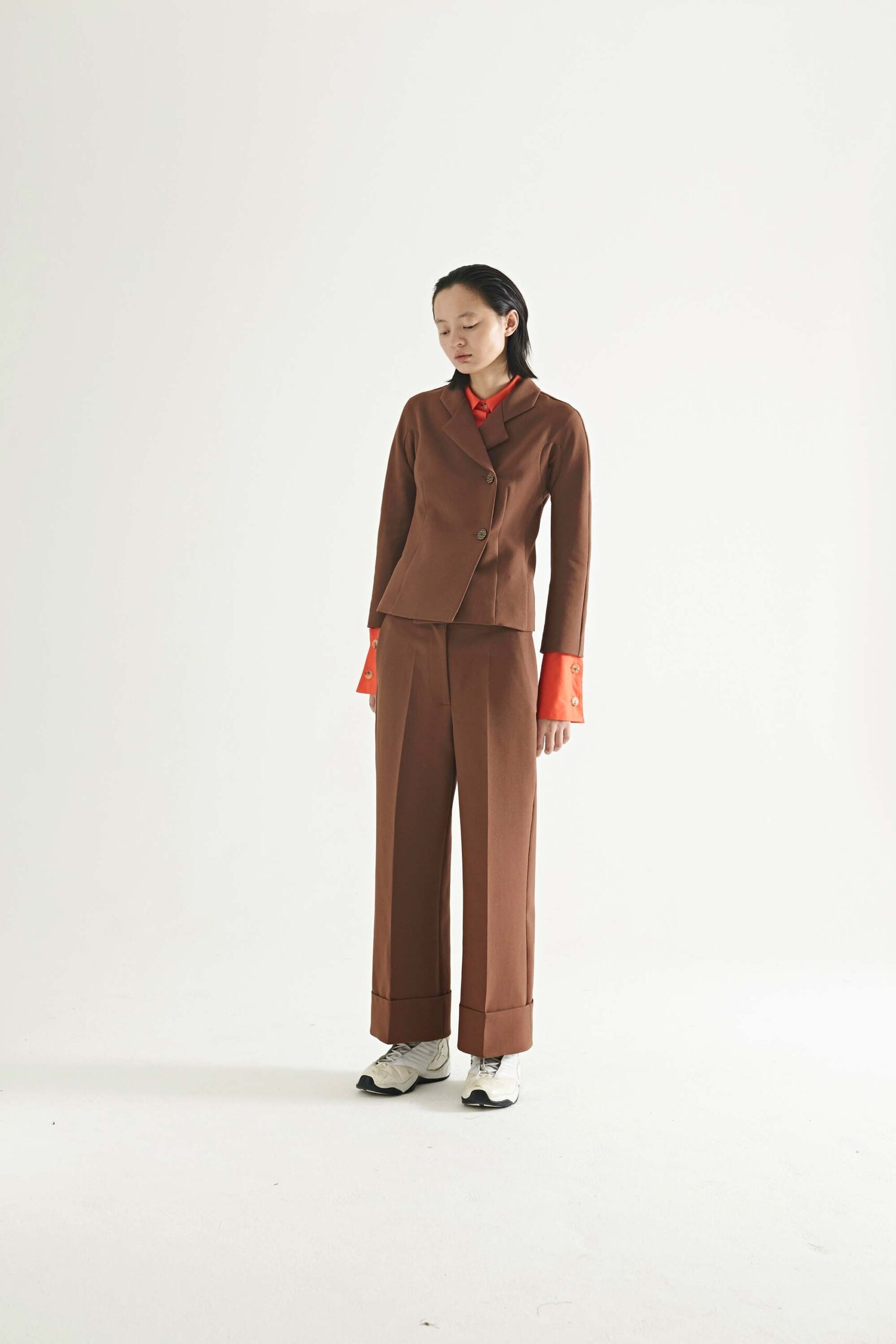 brown tailored suit with red shirt