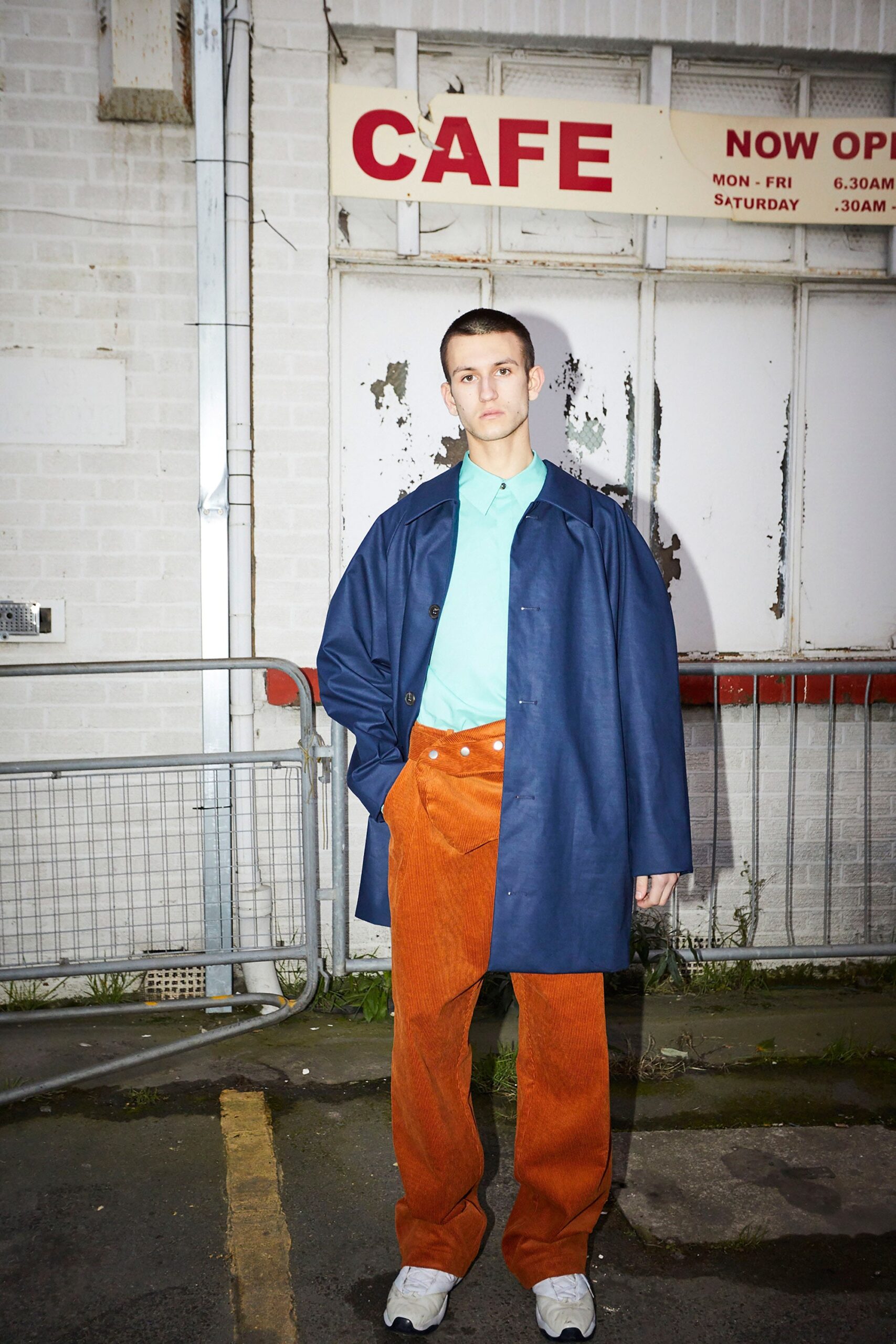 blue coat green shirt orange pants