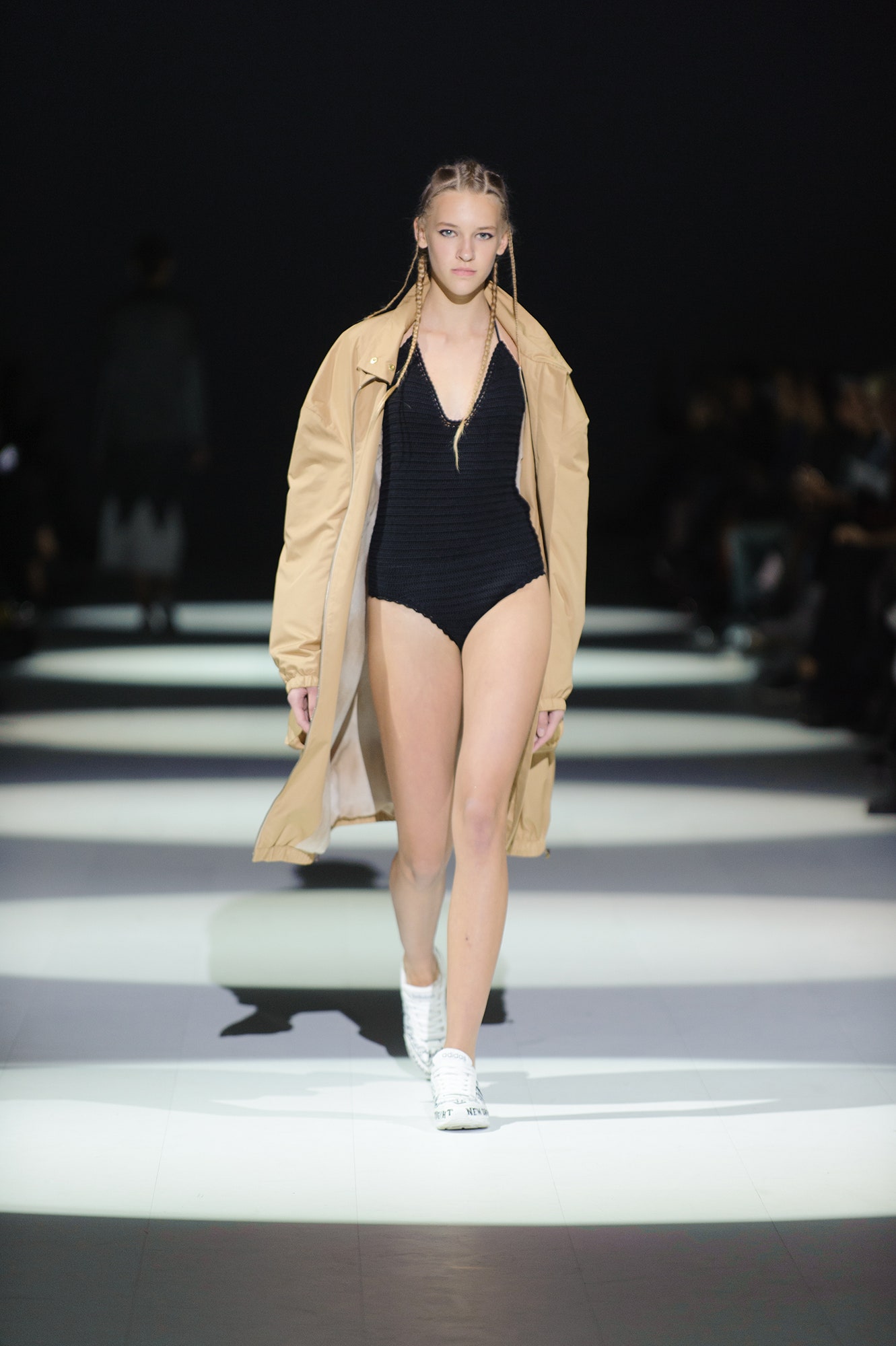 black swimsuit with beige coat