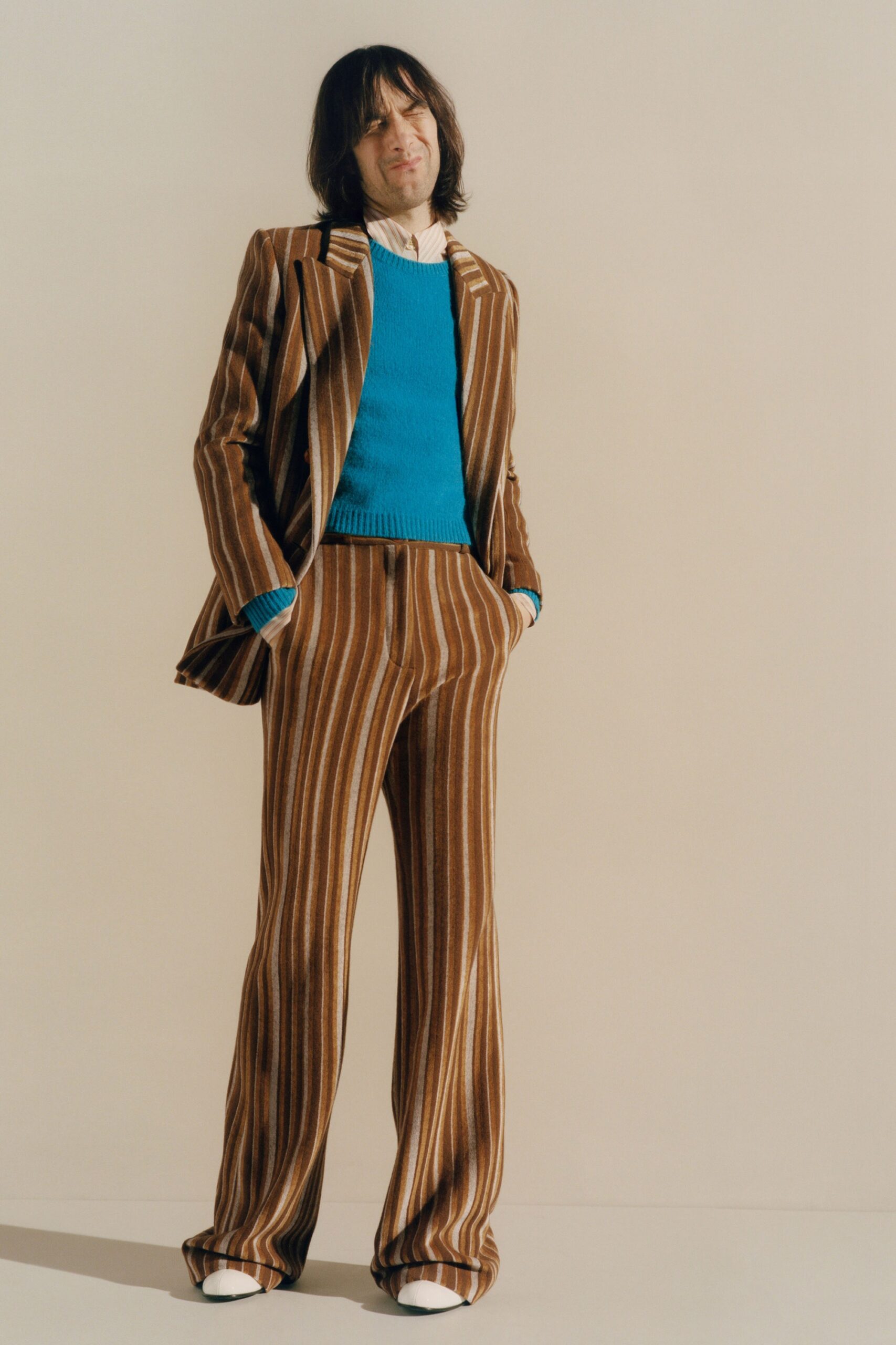 striped brown suit with blue sweater