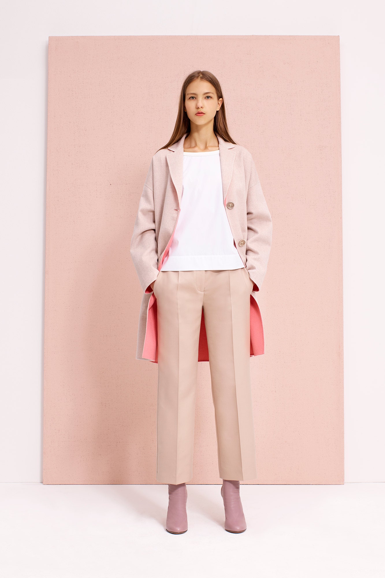 pink coat with white top and beige pants