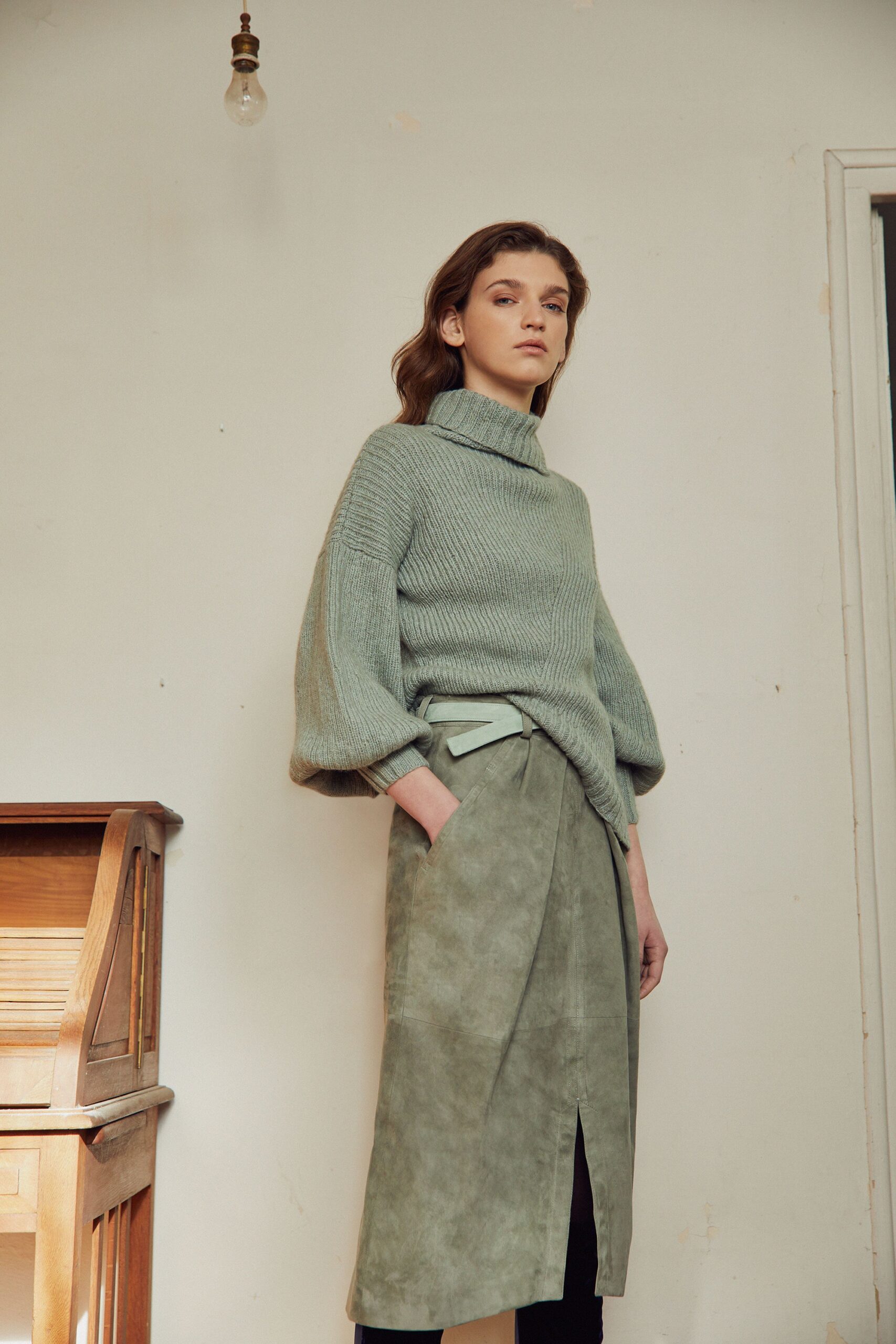green wool sweater and beige suede skirt