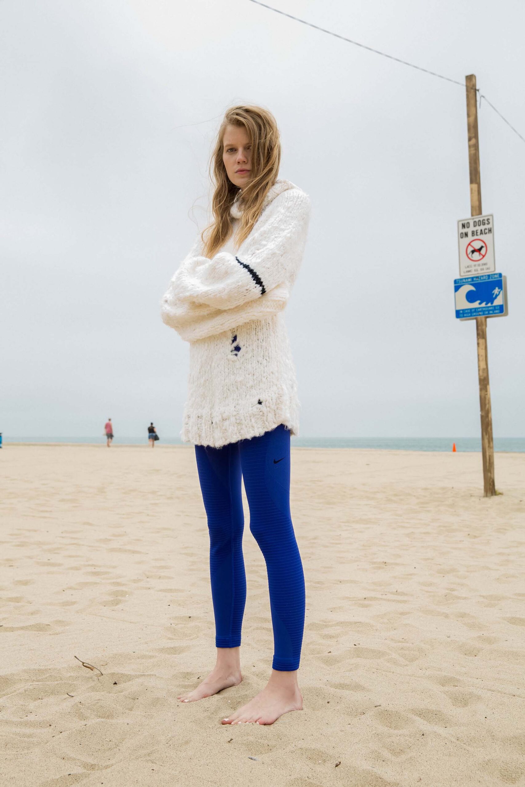 white wool relaxed sweater and blue leggings