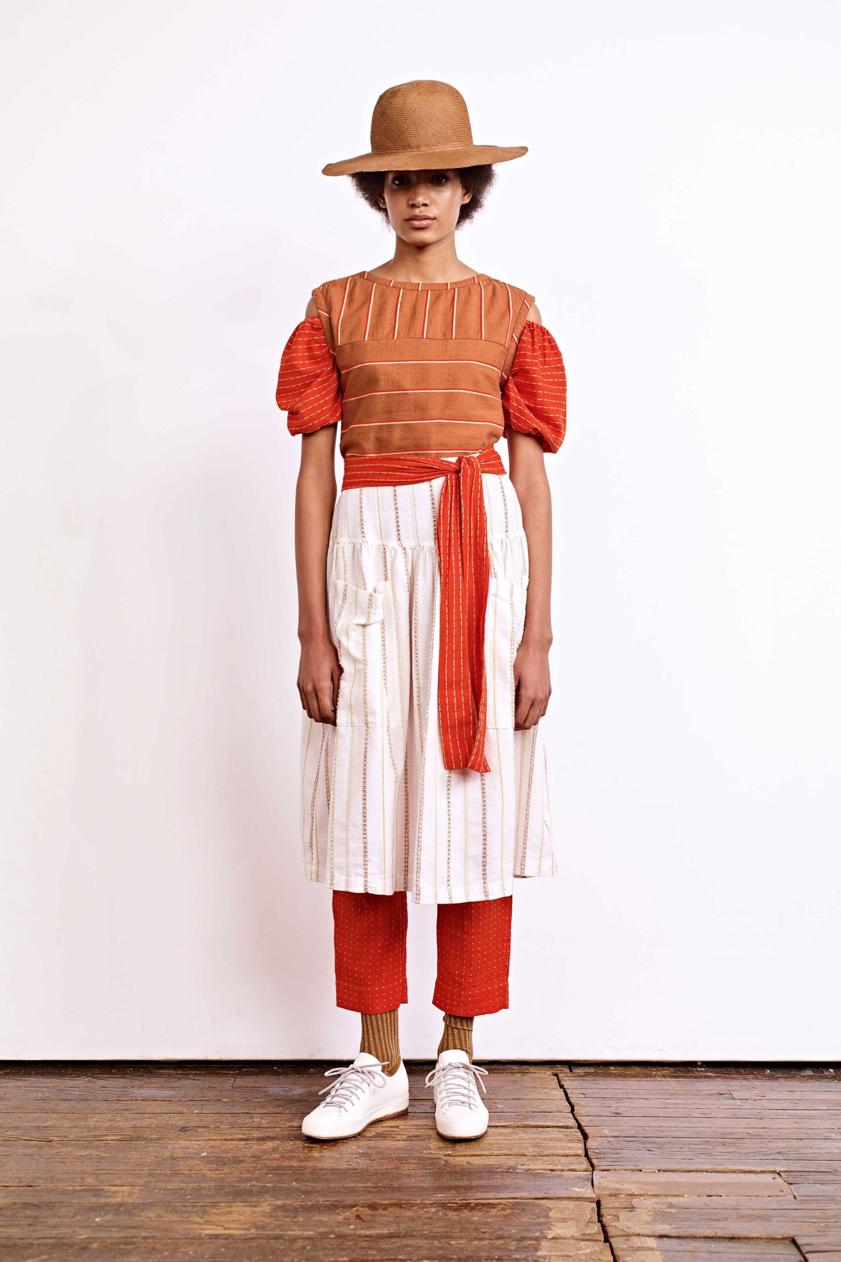 orange and brown top with pleated pants