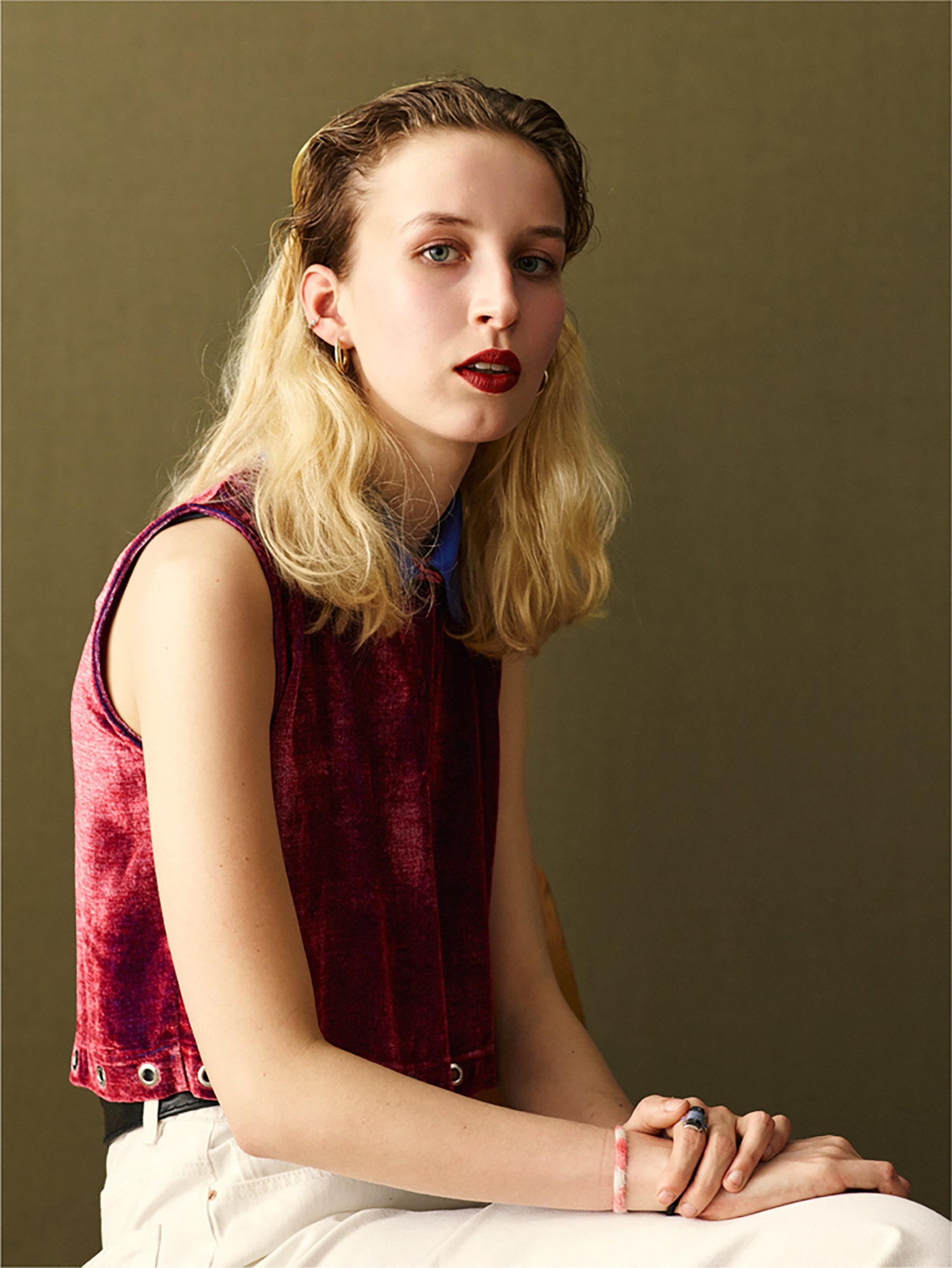 red velvet sleeveless top and white tailored pants