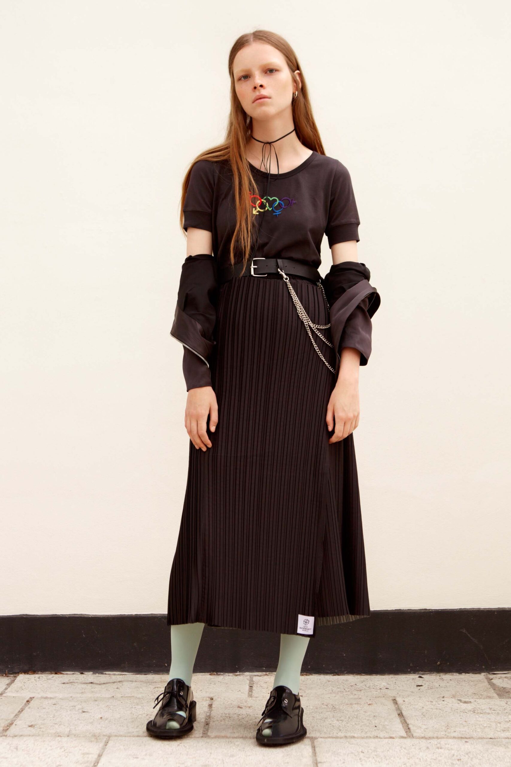 black fitted top and pleated skirt